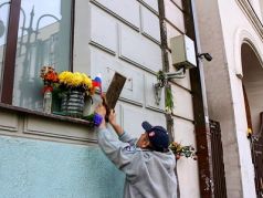 Активист движения SERB снимает мемориальную табличку Бориса Немцова. Фото: RTVI